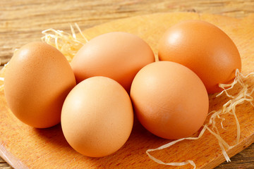 Brown eggs on cutting board