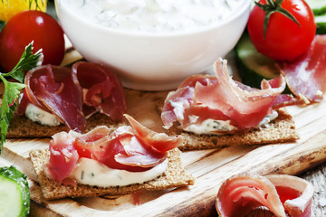 Snack sandwiches with dried ham, sauce, cottage cheese on rye cr