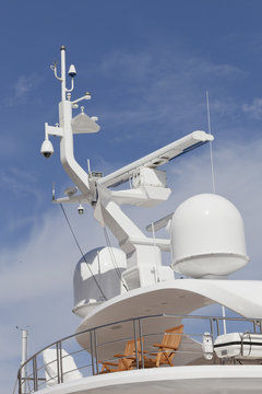 Top Deck Of A Luxury Super Yacht With 2 Wooden Chairs, Above Navigational Radar And Aerial