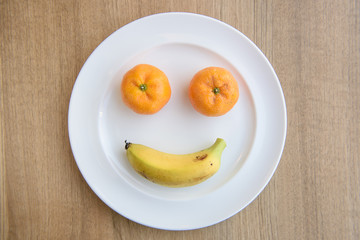 smiling face from fruits on plate