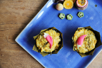 steamed fish with curry paste on wood background