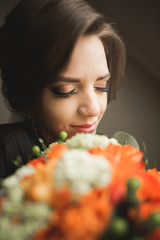 Fototapeta premium Luxury bride in black robe posing while preparing for the wedding ceremony