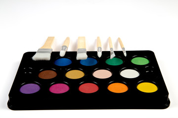 White paintbrushes with wooden handle and color paint