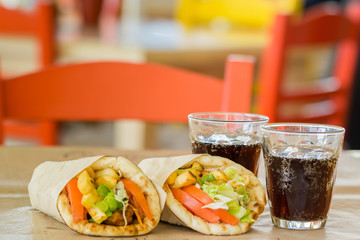 Greek cuisine, souvlaki, gyro pita. and a glass of drink. In the tavern in Greece