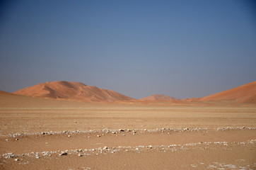 Fototapeta na wymiar White rocks and sand dunes sahara