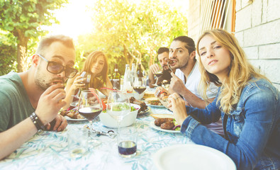 Group of friends making barbeque in the backyard
