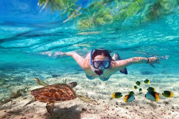 Wall murals Diving Beautiful women snorkeling in the tropical sea