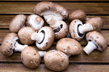 Brown champignon on wooden background 