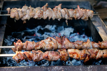 Grilling marinated shashlik on a grill