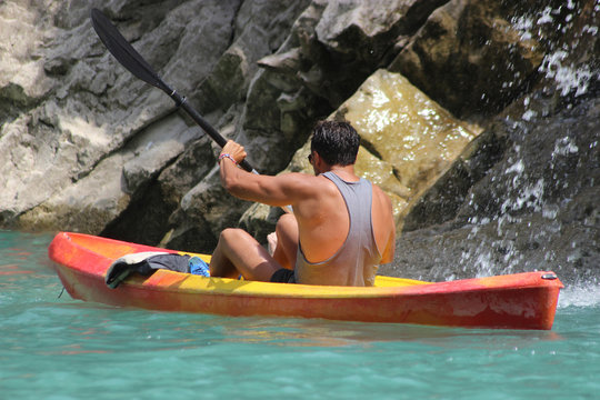 Young Man Kayaking in the River
