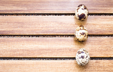 Quail eggs on wooden background 