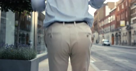 Contemporary funky caucasian businessman street dancer dancing freestyle in the city