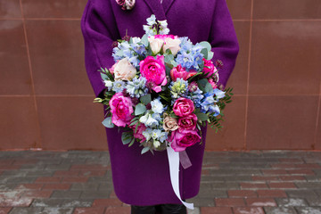 Woman holding beautiful bouquet of flowers