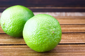 Limes on wooden background 