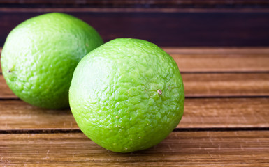 Limes on wooden background 