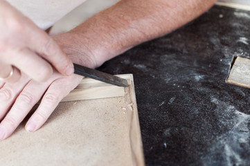 Carpenter is working with chisel