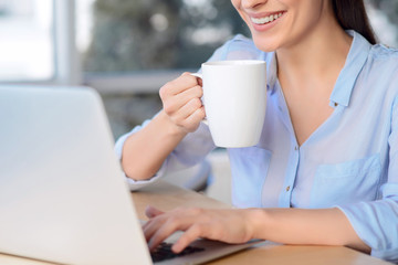 Pleasant business woman sitting at the table 