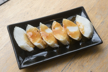 fresh black cod or sable fish on black dish for grill