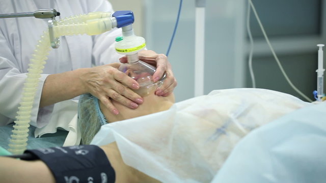 The girl on the operating table. The patient was put on an oxygen mask. Dolly shot