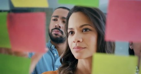 Creative business team brainstorming ideas working together sharing data late at night after hours in modern glass office - Powered by Adobe