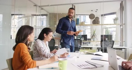 Creative Business team meeting businessman manager presenting financial data to shareholders using digital tablet in casual modern office boardroom with natural light and large open windows - Powered by Adobe