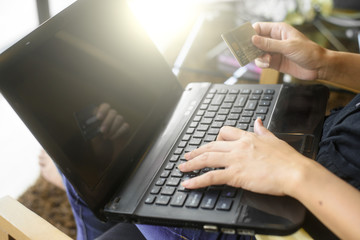 Close Up Of A woman Shopping Online Using Laptop With Credit Car