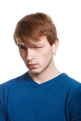 Obraz premium strict handsome young man in a blue sweater isolated on a white