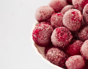 frozen cherries in the plate on white background