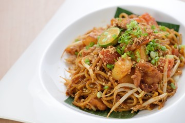 Indian style spicy fried noodles, ready to serve on dining table.