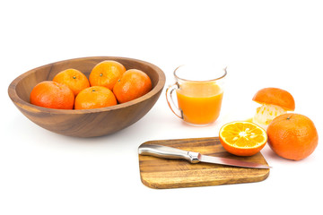Fresh oranges and orange juice on white background