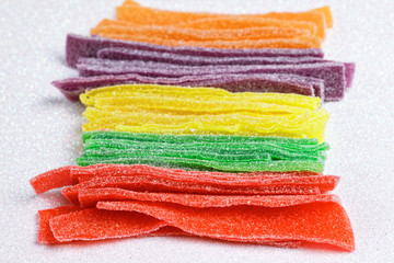 Colorful sugar jelly candy strip over white background