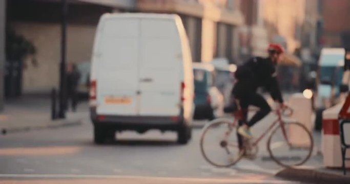 Anonymous crowd of people walking cycling bicycles commuters London City street slow motion