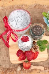 Chia seeds with milk and fresh strawberries.
