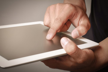 Hand touching a tablet.
