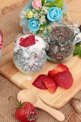 Chia seeds with milk and fresh strawberries.