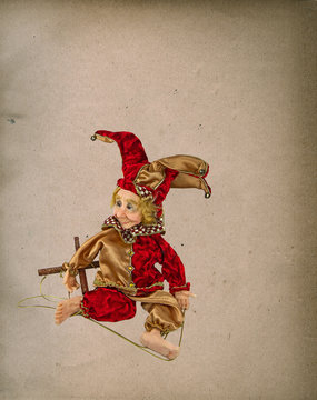 Vintage Jester puppet on grunge paper texture background
