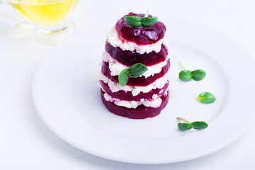 salad of roasted red beets and feta cheese with olive oil on a white background