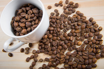 coffee beans in cup. Coffee cup and coffee beans on wooden background. coffee with cinnamon, coffee with additives
