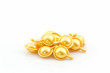 Hair vitamin serum capsule gold color.