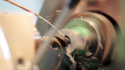 Close up machining tool drill during metal cutting process boring a hole