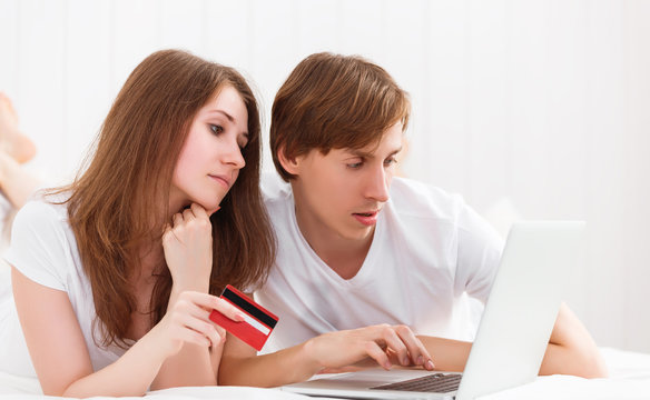 happy couple makes online shopping with laptop and credit card a