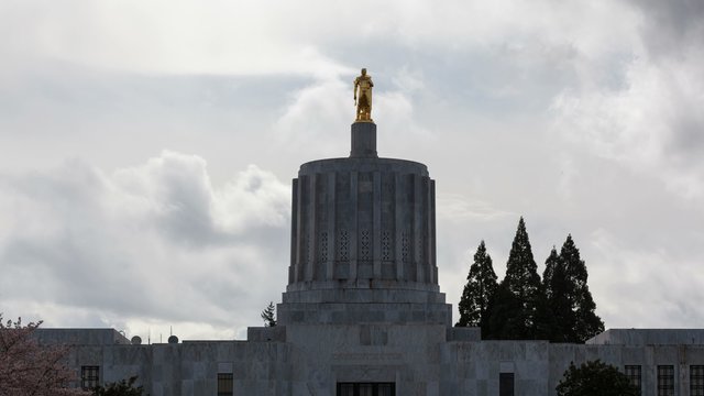 Ultra High Definition 4k Time lapse movie of dramatic moving clouds and sky over closeup on Salem State Capitol in Oregon during spring season 4096x2304