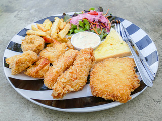Fried seafood in plate with salad