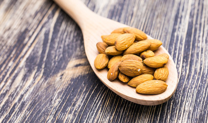 Almonds in wooden spoon 