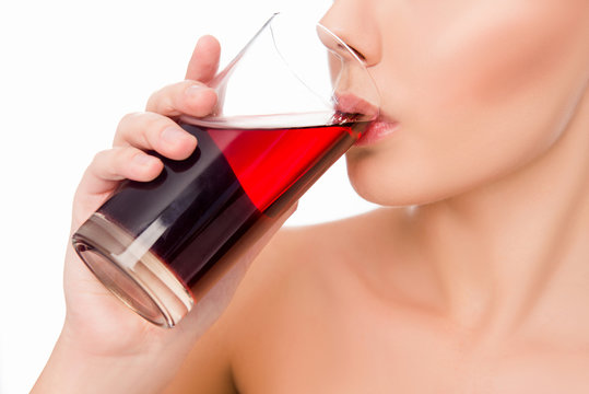 Close up photo of sensitive  woman drinking cherry juice