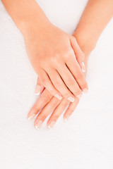 Close up photo of woman's hand with manicure on white background
