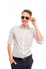 Obraz premium Handsome man touhing his spectecles and holding hand in pocket