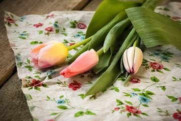 Pink tulips on wooden table