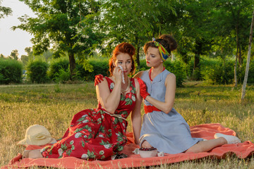 Girl on a picnic and sit gossiping. retro style