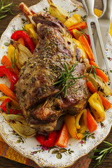 Roast leg of lamb with rosemary and garlic and vegetables.